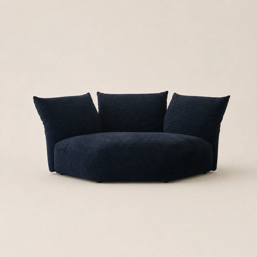 Navy blue sofa with three cushions on a beige background