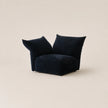 Black bean-shaped chair on a beige background