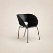 Black chair with ribbed design on a beige background