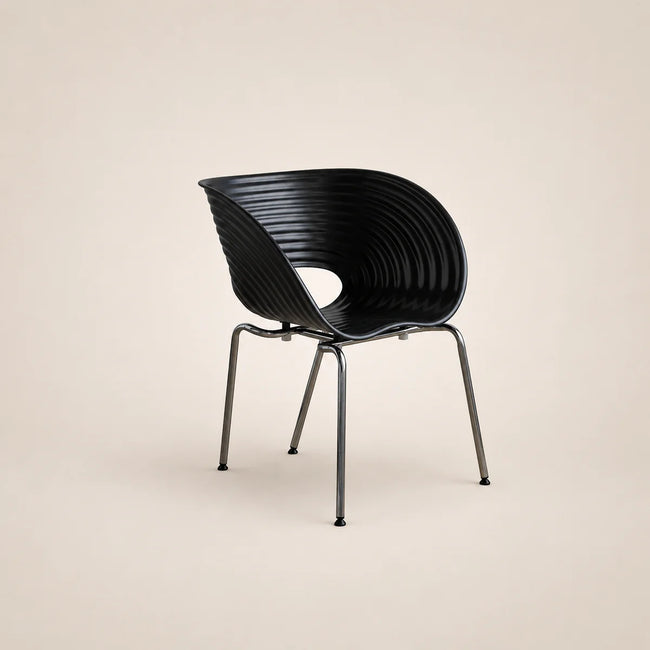 Black chair with ribbed design on a beige background