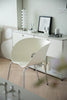 Modern interior with a white living room chair and a sideboard in a minimalistic room.