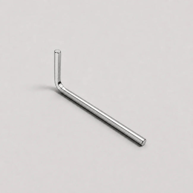 A silver metal hex wrench with an L-shaped head, shown diagonally on a light gray background.