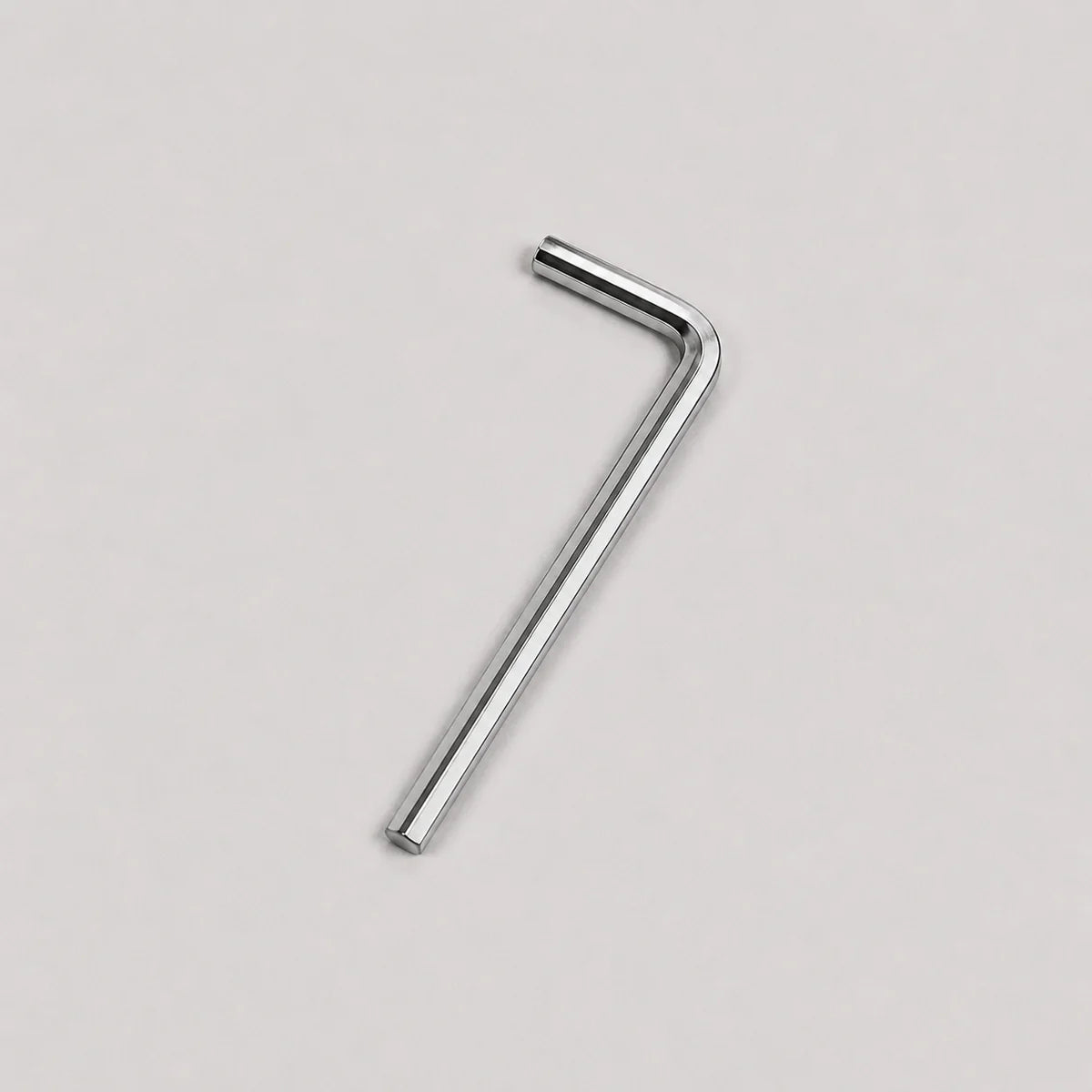 A small silver metal hex wrench with a straight shaft and bent handle, shown on a plain light gray background.