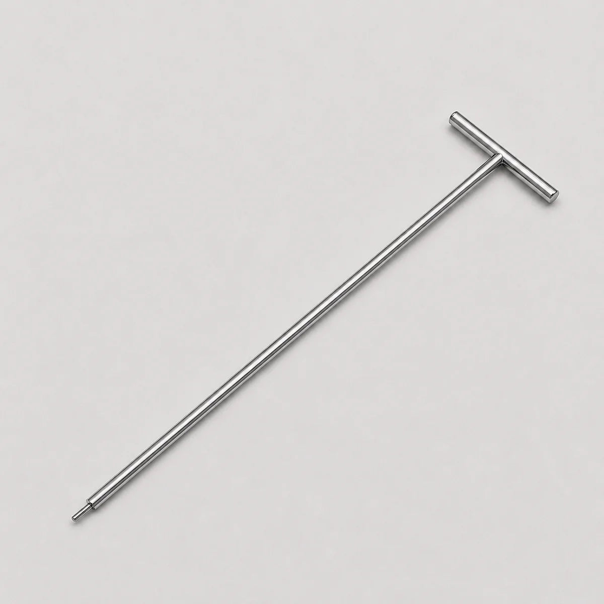 A silver metal T-handle tool with a long shaft and a flat perpendicular end, shown diagonally on a light gray background.