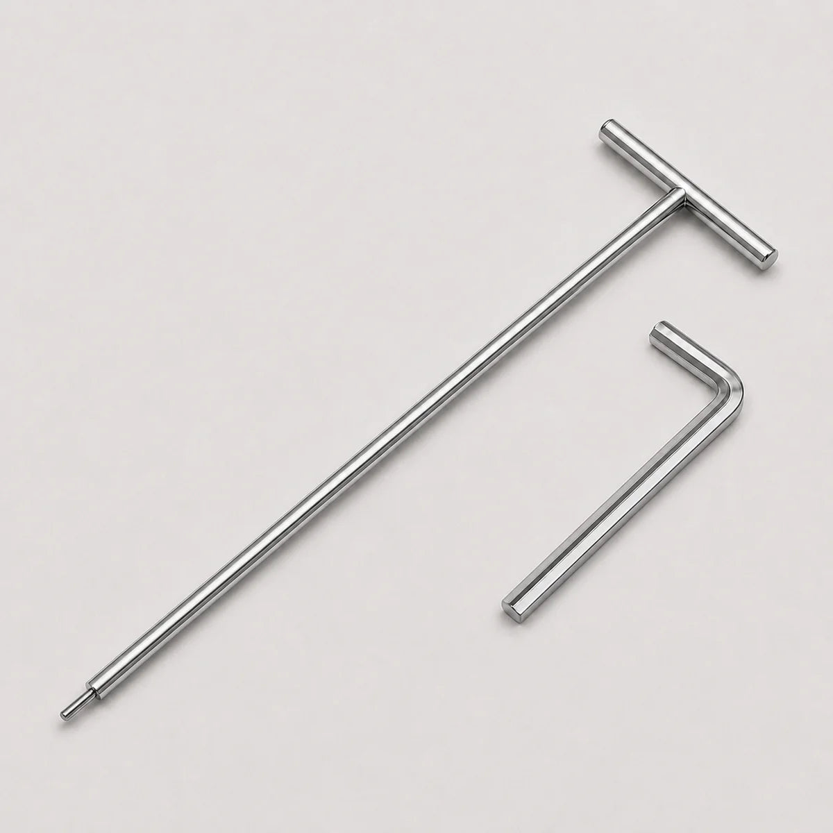 A silver metal T-handle hex wrench and matching hex key shown on a light gray background.