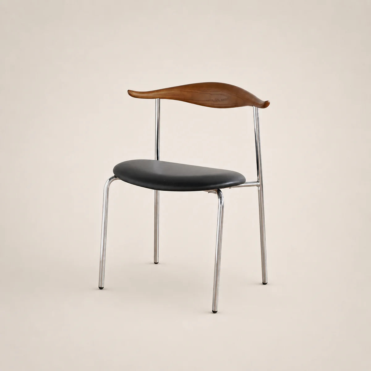 Chair with black seat and wooden backrest on a beige background