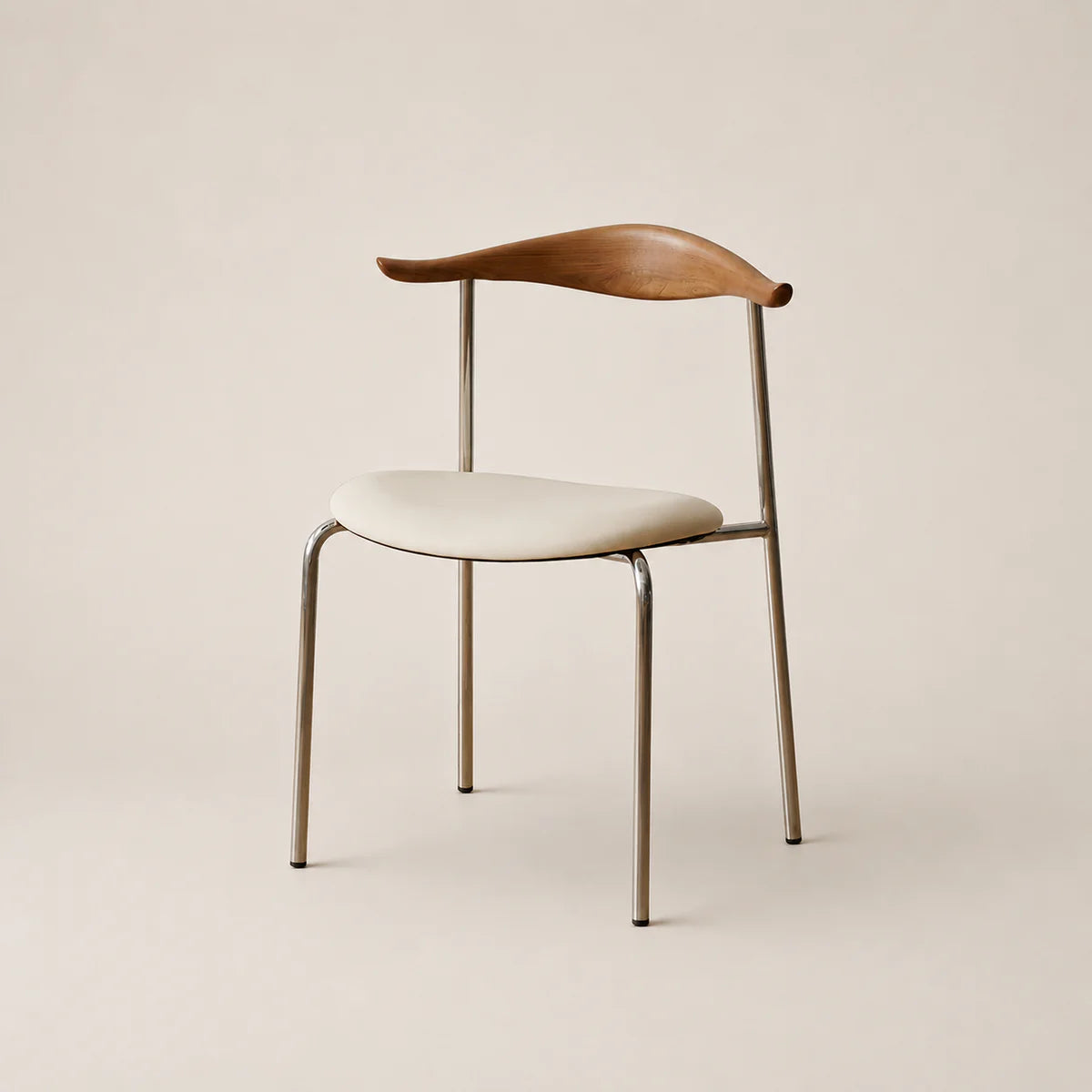 Chair with wooden backrest and white seat on a beige background