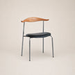 Chair with wooden backrest and black seat on a beige background
