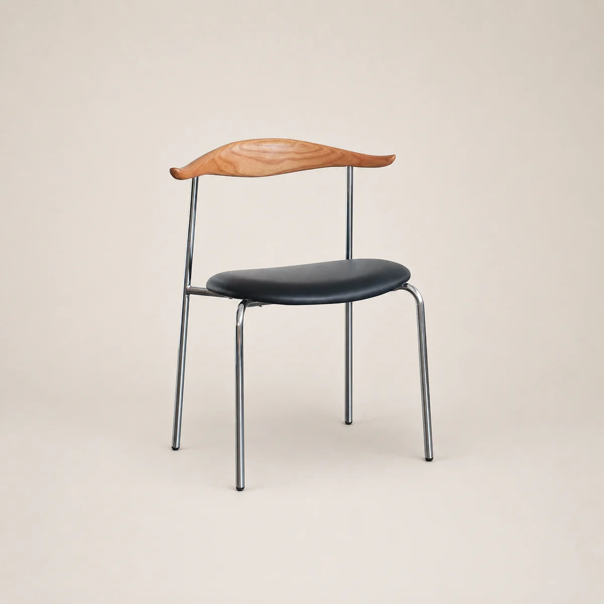Chair with wooden backrest and black seat on a beige background