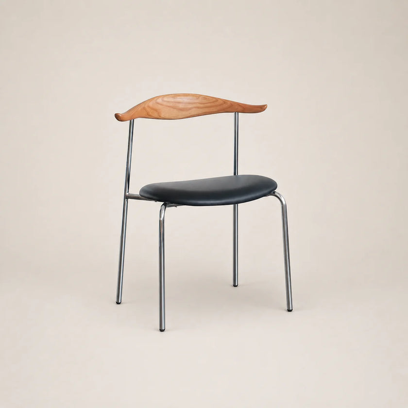 Chair with wooden backrest and black seat on a beige background