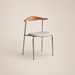 Modern chair with wooden backrest and light-colored seat on a beige background