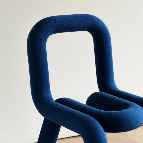 Modern blue chair with a minimal white background