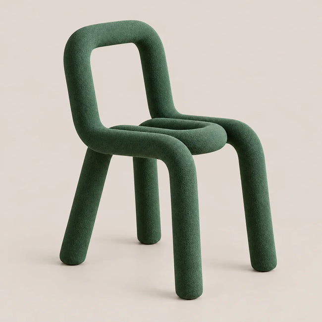 A modern sculptural chair upholstered in a textured dark green fabric, featuring a thick rounded backrest and legs, set against a solid light beige background.