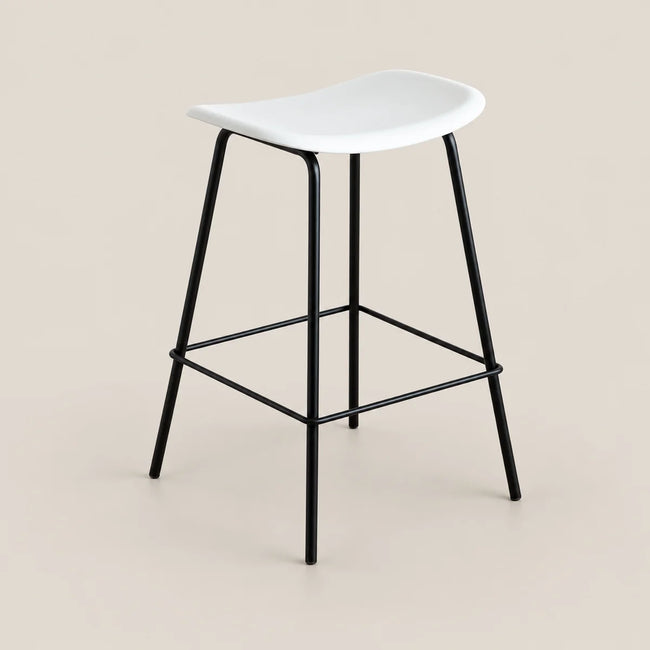 A modern counter stool with a white molded seat and a black metal frame with a footrest, set against a solid beige background.