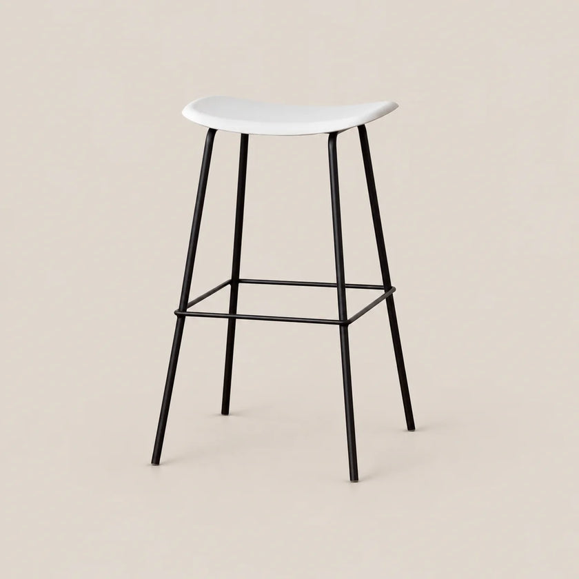 A modern bar stool with a white molded seat and black metal legs, shown against a solid light beige background.
