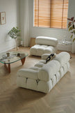 Modern white sofa in a living room with wooden floor and window blinds.