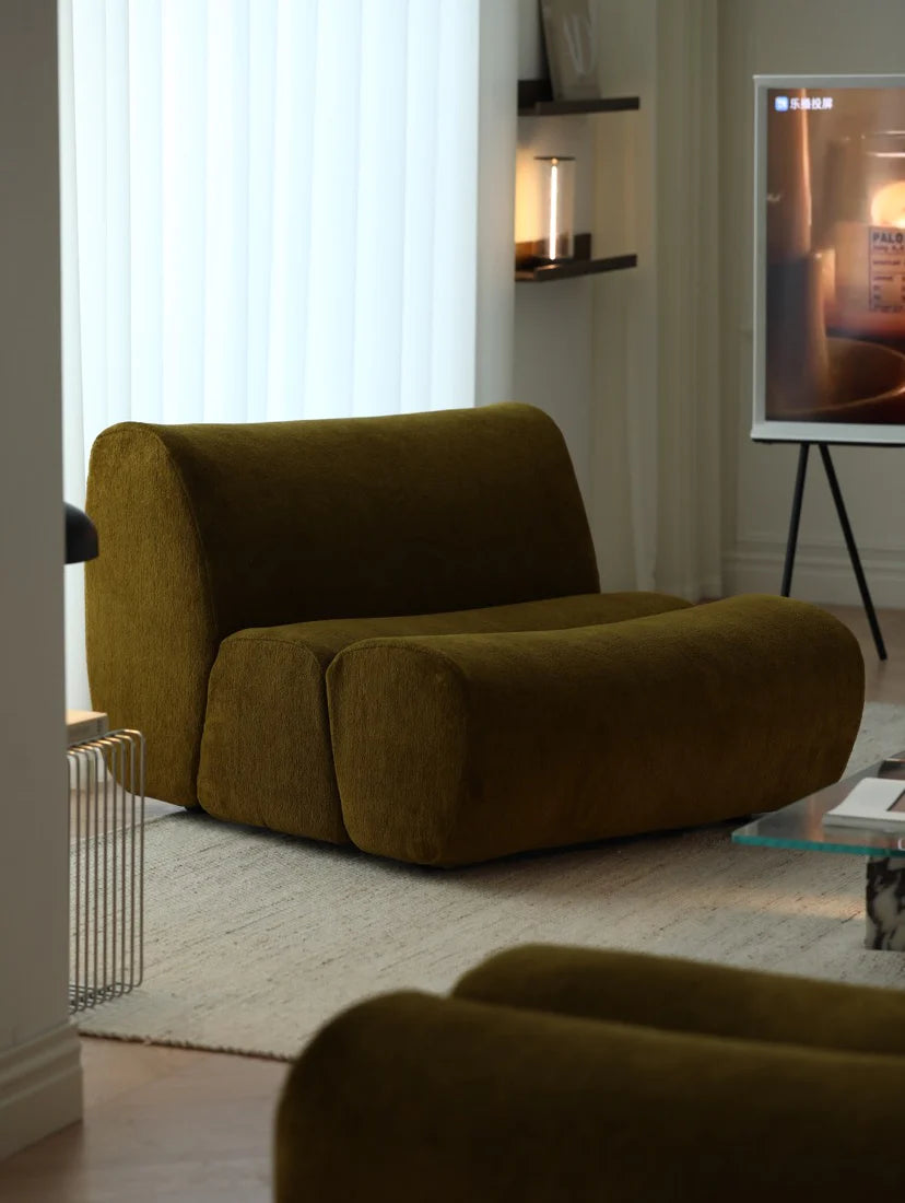 Brown armchair in a modern living room with a TV in the background