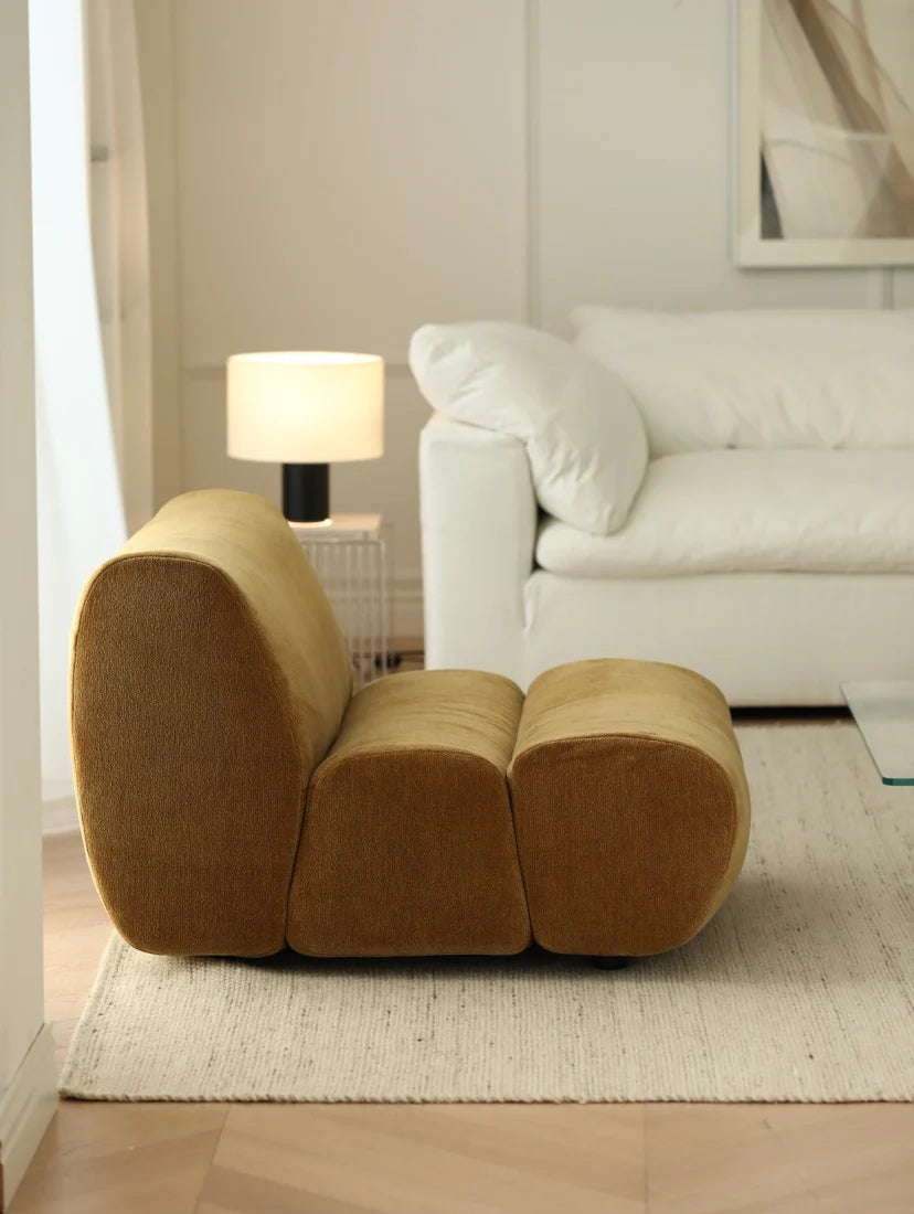 Brown modular sofa in a living room with a white couch and lamp.