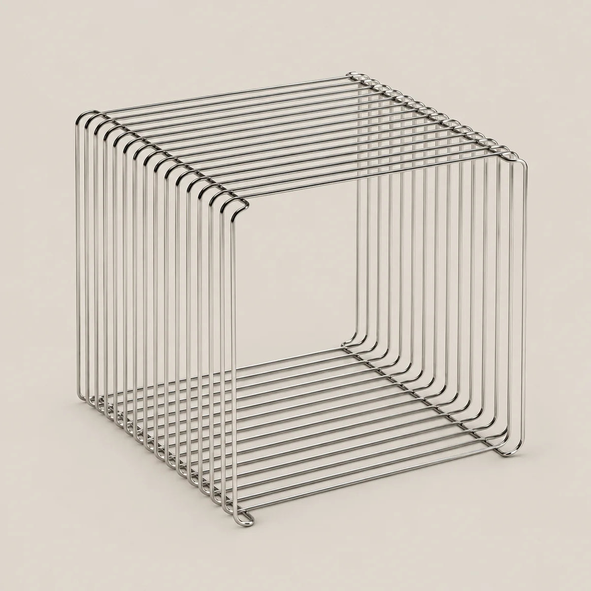 A minimalist, open-frame cube side table made of thin, polished metal wire with a brushed silver finish, set against a solid, warm off-white background.