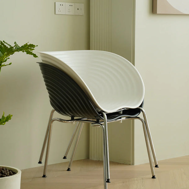 Modern chair with black and white design in a minimalistic room.