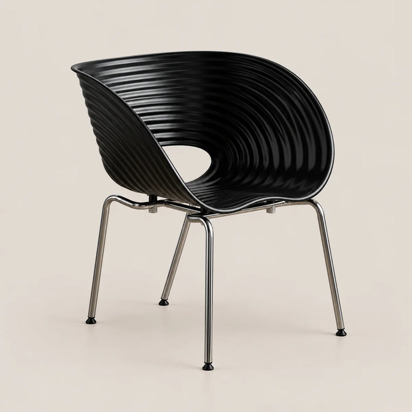 A modern black molded plastic chair with a ribbed, wave-like backrest and slim chrome legs, shown against a solid light beige background.
