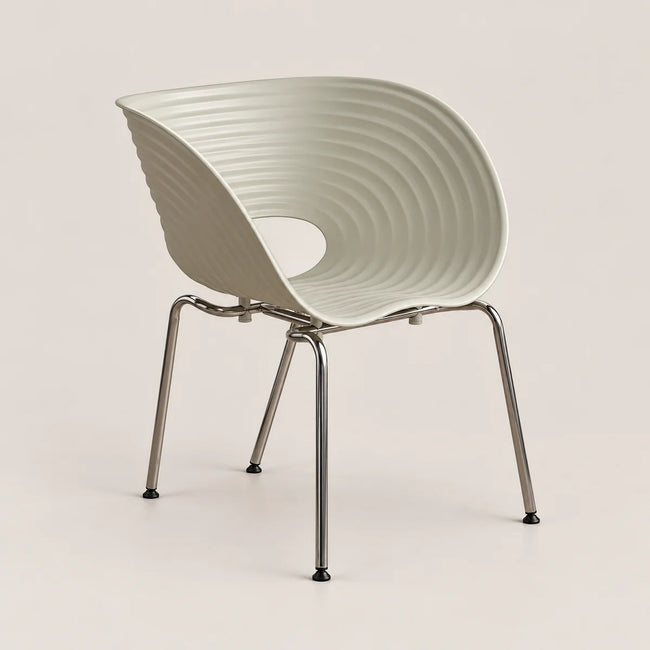 A modern molded plastic chair with a ribbed, curved shell and slim metallic legs, shown against a solid light beige background.