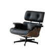 Black leather lounge chair with wooden armrests on a white background