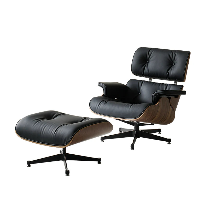 Black leather lounge chair and ottoman on a white background
